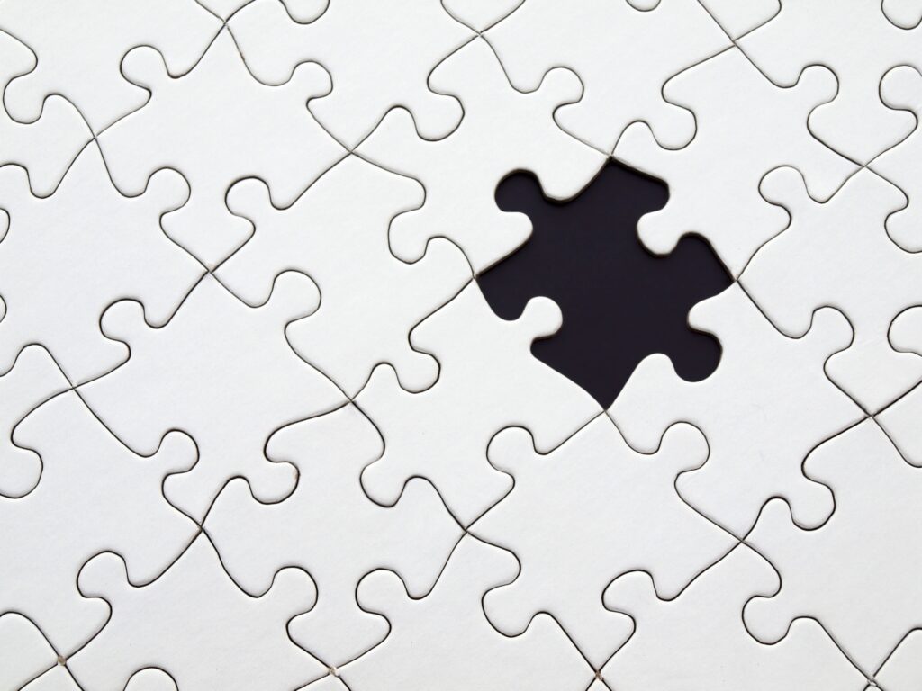 a jigsaw puzzle with a missing piece to represent missing connections in Apraxia.