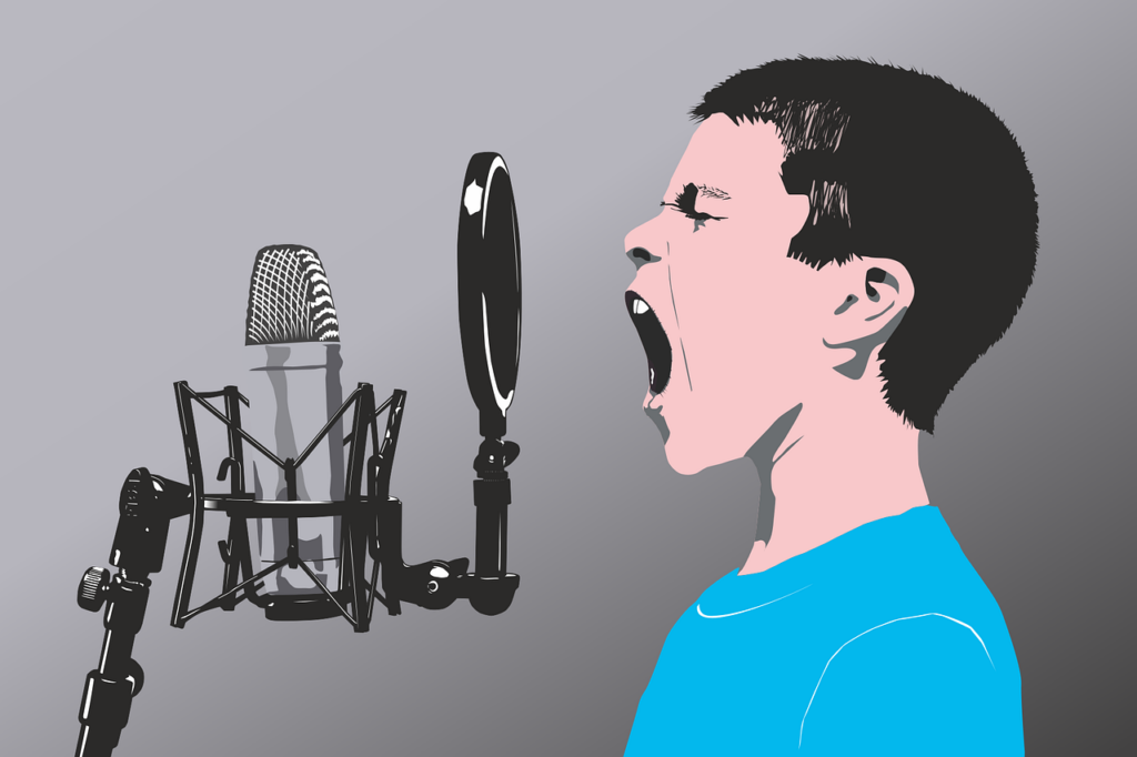 An image of a boy shouting into a microphone, probably straining his voice!